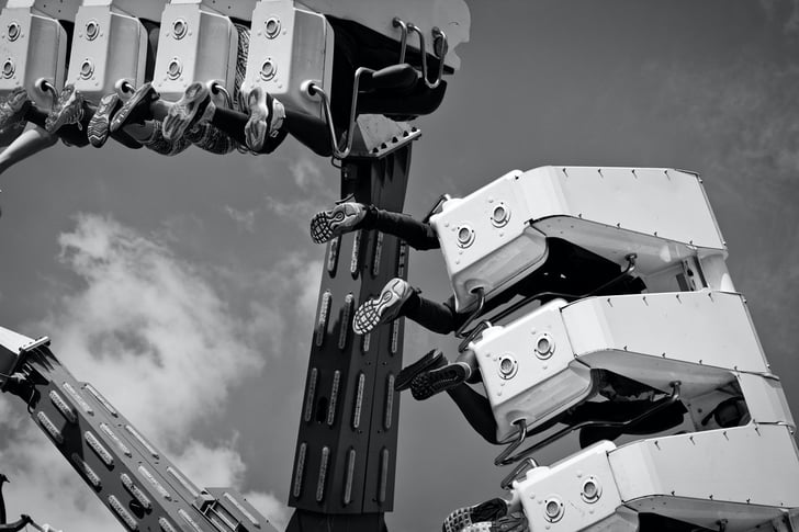 people riding a robotic amusement park ride